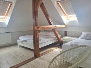 卢布尔雅那AZUR ROOMS LJUBLJANA的阁楼间 - 带一张床和一把椅子