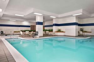 都柏林Embassy Suites by Hilton Columbus Dublin的蓝色水的酒店客房的游泳池
