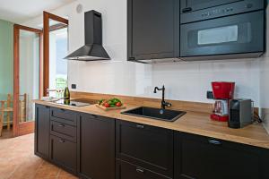科斯特曼诺VILLA IDA - Regarda Travel的厨房配有水槽和微波炉