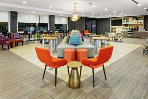 舒格兰Home2 Suites By Hilton Sugar Land Rosenberg的一间配备有沙发及桌椅的自助餐厅