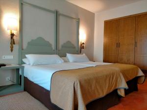 贝纳文特贝纳文蒂旅馆的一间卧室配有一张带白色床单的大床