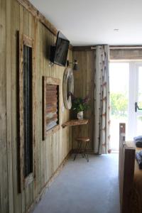 阿博伦The Moo-tel at Bargoed Farm的客厅设有木镶板和墙上的电视