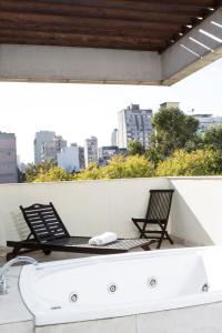 墨西哥城Suites Giorgio的两把椅子和一个屋顶浴缸