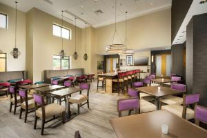 圣安东尼奥圣安东尼奥西北/医疗中心汉普顿套房酒店 的一间带桌子和紫色椅子的用餐室