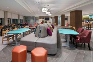 奥兰多Home2 Suites By Hilton Orlando Near UCF的一个带桌子和沙发的等候区
