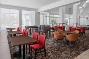 盐湖城盐湖城机场希尔顿花园酒店 的餐厅设有桌椅和窗户。