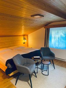 皮茨河谷圣莱昂哈德Apart Berghof Steinbock的一间卧室配有一张大床和两把椅子