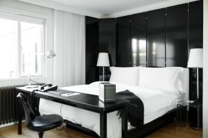 雷克雅未克101 Hotel, a Member of Design Hotels的卧室配有黑白床和书桌。