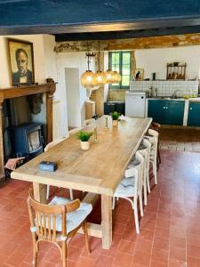 BrassyRuime woning in de Morvan, Bourgogne met seizoensgebonden zwembad的厨房里配有一张大木桌和椅子