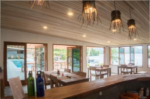Airtembago塔拉萨雷姆贝潜水度假村的用餐室设有桌椅和窗户。