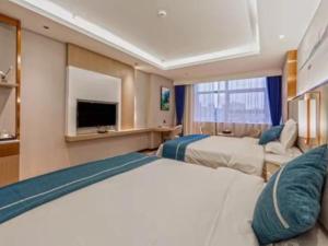 Yinzhan格林东方都匀瓮安县锦美时代汽车站酒店的酒店客房设有两张床和电视。