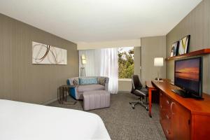 奥克兰奥克兰中心万怡酒店的酒店客房配有一张床、一张书桌和一台电视。