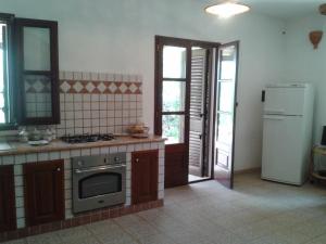 科尔萨诺Mirto的厨房配有炉灶和冰箱。