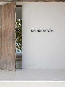 巴拉格兰德KA BRU Beach Boutique Hotel的带有读卡亚布鲁斯海滩标志的窗口