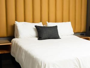 伯格斯堡Honolulu Lifestyle Guest Lodge的一张白色的大床,上面有灰色的枕头