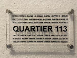 科瑟罗Seeblick Wohnung 113 mit teilw Meerblick的墙上读着四分之一的标语