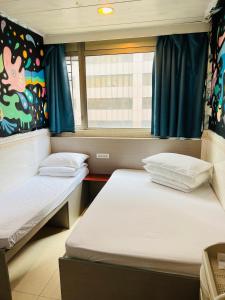 香港嘉應賓館HAKKAS GUEST House的小型客房 - 带2张床和窗户