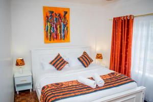 卡伦Classy African - themed 1 BR apartment in Karen的一间卧室配有一张床,上面有两条毛巾