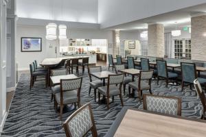 塔奇拉西雅图希尔顿惠庭套房酒店 - 塔科马机场/塔奇拉的一间带桌椅的用餐室和一间酒吧