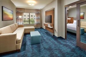 圣地亚哥圣地亚哥/海洋世界区希尔顿惠庭套房酒店的酒店客房设有沙发、床和电视。