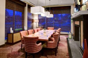 阿尔法利塔亚特兰大北/阿尔法利塔希尔顿花园酒店的用餐室配有大型木桌和椅子