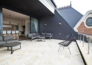 布达佩斯ZOYA LUXURY RESIDENCE的一个带沙发和桌子的庭院和一个楼梯