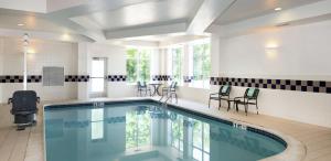 华盛顿堡费城华盛顿堡希尔顿花园旅馆的一个带椅子和桌子的大型游泳池