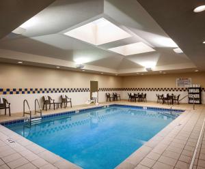 奥马哈奥马哈市区老集市区希尔顿花园旅馆的酒店客房的游泳池配有桌椅