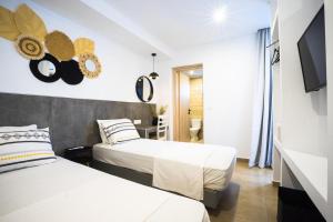 法里拉基Mousikorama Apartments的一间酒店客房,设有两张床和电视