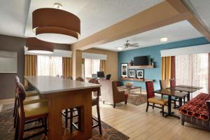 钱德勒凤凰城钱德勒汉普顿酒店的用餐室以及带桌椅的起居室。
