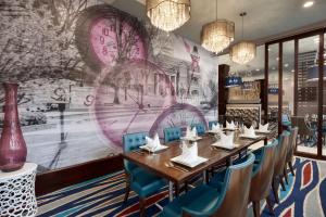德卢斯亚特兰大东北格威内特舒格洛夫希尔顿合博套房酒店的一间带长桌和蓝色椅子的用餐室
