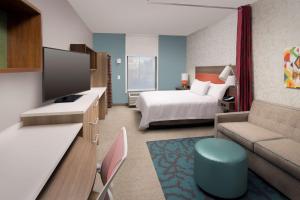 默夫里斯伯勒Home2 Suites By Hilton Murfreesboro的酒店客房设有床和客厅。
