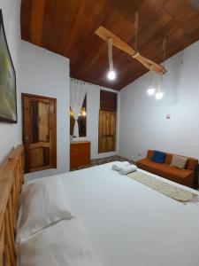 比亚米尔港Sky Blue Hospedaje的卧室设有白色大床和木制天花板。