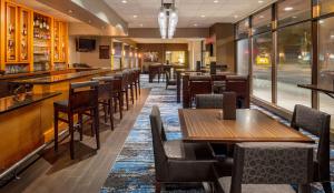 明尼阿波利斯DoubleTree Suites by Hilton Minneapolis Downtown的一间带桌椅的餐厅和一间酒吧