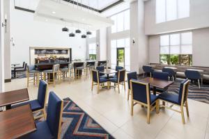 千橡市千橡市汉普顿套房酒店的用餐室设有桌椅和窗户。