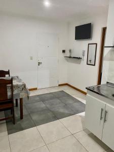 伊瓜苏港Santino Apart的客房设有带桌子和电视的厨房。