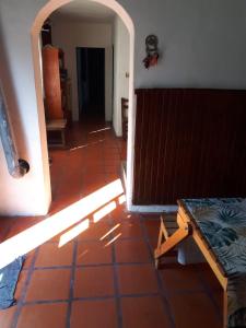 罗萨里奥Alojamiento hostel Lodeolga "La Florida"的一间铺有红色瓷砖地板的客房和一扇开放式门