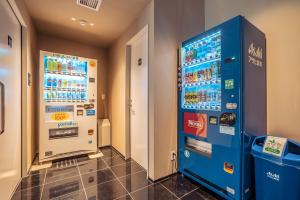 大阪谷町君Hotel 難波77的客房内的一台蓝色自动售货机