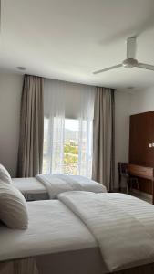 Salmahبيوت الخزام的酒店客房设有四张床和窗户。