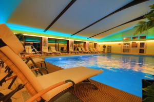 拉姆贝尔瓦尔德酒店的一个带椅子和桌子的大型游泳池