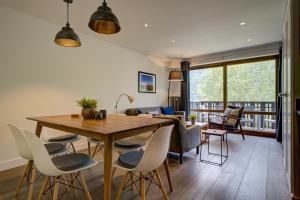 夏蒙尼-勃朗峰Le Brevent 3 Apartment的客厅配有木桌和椅子