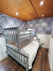 利物浦泰坦尼克号酒店的配有蓝色和白色壁纸的客房内的一张双层床