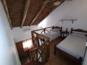 科隆Cabañas del Paraiso的客房设有两张床,铺有木地板。