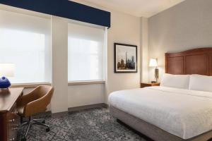 纽约曼哈顿/闹市区汉普顿旅馆 - 金融区的酒店客房设有一张床、一张书桌和窗户。