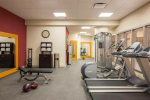 皇后区Hilton Garden Inn Long Island City的健身房设有跑步机、有氧器材和时钟
