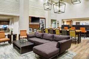 匹兹堡Hampton Inn & Suites Pittsburg Kansas Crossing的带沙发的客厅和用餐室