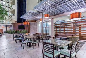 纳什维尔Embassy Suites by Hilton Nashville Airport的餐厅设有桌椅和沙发。