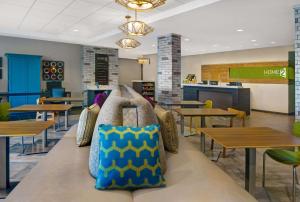 ArdenHome2 Suites By Hilton Asheville Airport的一间设有桌子和配有枕头的长凳的自助餐厅