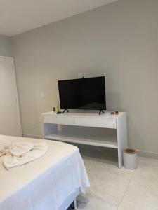 卡诺格布拉达Charlotte House的客厅配有白色桌子上的电视