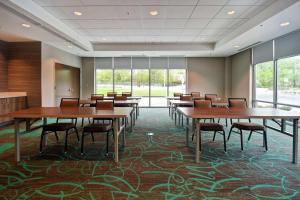 福克斯伯勒Home2 Suites By Hilton Walpole Foxborough的一间会议室,配有桌椅和窗户